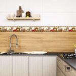 Cenefa cerámica decorativa dk-1686 8 x 25 cm-tiles-2-ok | Plomería García Kitchen scene with a stainless sink and flexible pull-down faucet, light wood lower cabinets, and a tile backsplash with a jar-and-food motif.