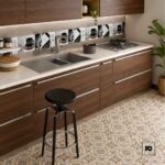 Modern kitchen with dark wood cabinets, a double stainless steel sink, and a gas cooktop with a black stool nearby.
