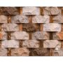 Stacked beige and brown stone veneer wall with rectangular blocks and vertical joints.