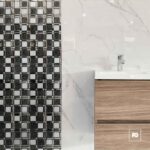 Malla decorativa echo de vidrio negro y blanco 30 x 30 cm-tiles-3-ok | Plomería García Modern bathroom vanity with white countertop, chrome faucet, and two wood drawers against marble walls; mosaic tile on the left.