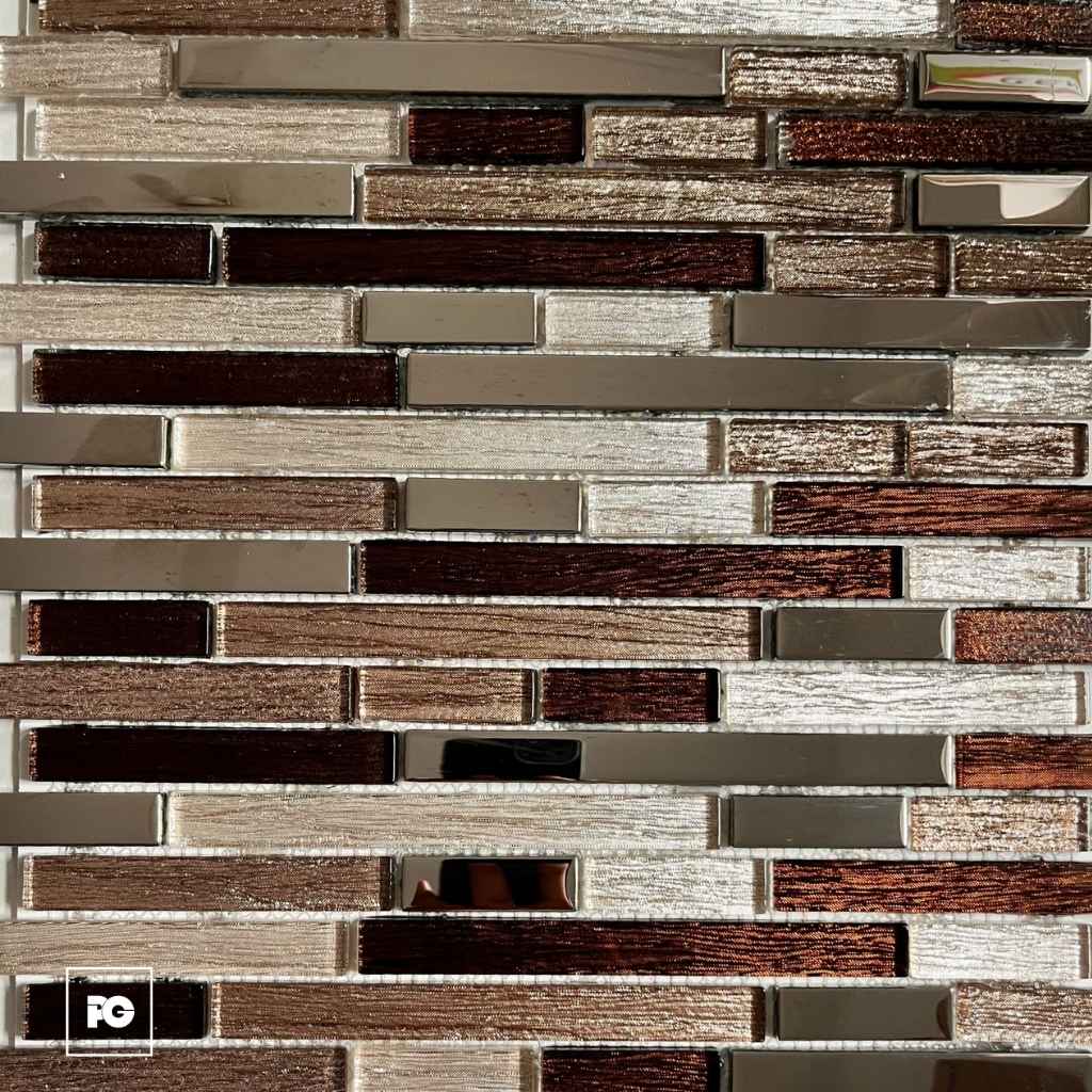 Close-up of a brown-toned glass and ceramic brick-pattern backsplash with metallic accents and glossy surfaces, no people present.