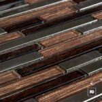 Close-up of parallel copper strips and silver metal spacers in an industrial grid.