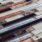 Close-up of metal rectangular troughs in a row, with weathered surfaces and coppery rust.