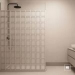 Modern bathroom with a glass block shower wall, black ceiling shower head, and a white vanity on the right.