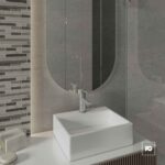 Modern bathroom vanity with a square white sink and chrome faucet against a gray tiled wall and mirror backdrop by the sink area edge.