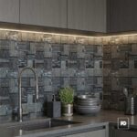 Malla decorativa jenner de vidrio y piedra gris 30 x 30 cm-tiles-2-ok | Plomería García Modern kitchen with dark square textured tile backsplash, stainless steel faucet, and a counter with plant and bowls.